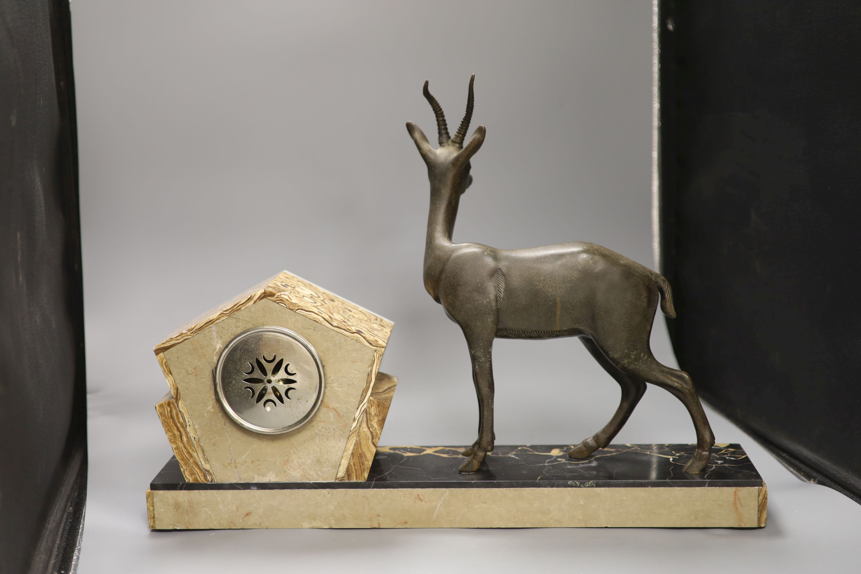 An Art Deco spelter, marble and onyx 'antelope' mantel clock, length 58cm